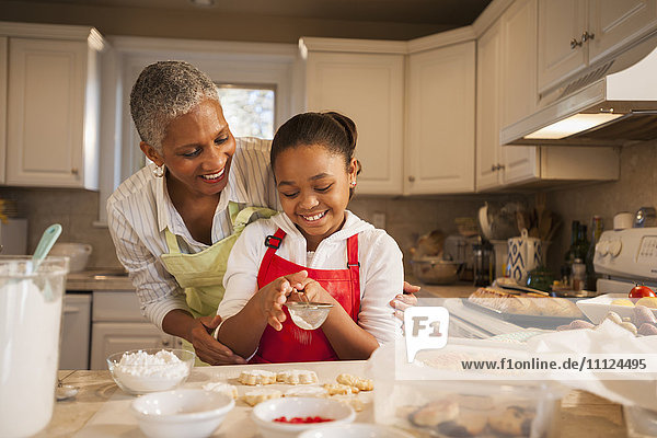 Woman and granddaughter baking in kitchen