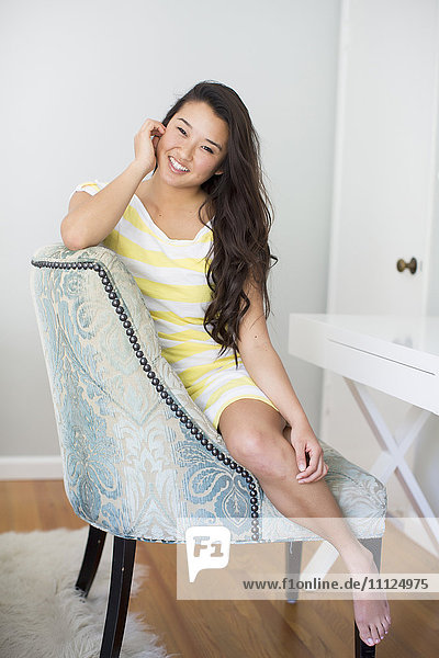 Japanese woman smiling in armchair