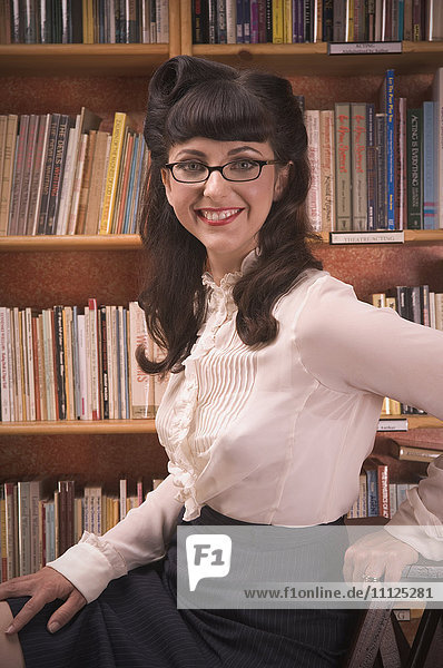 Portrait of woman wearing retro clothing in library