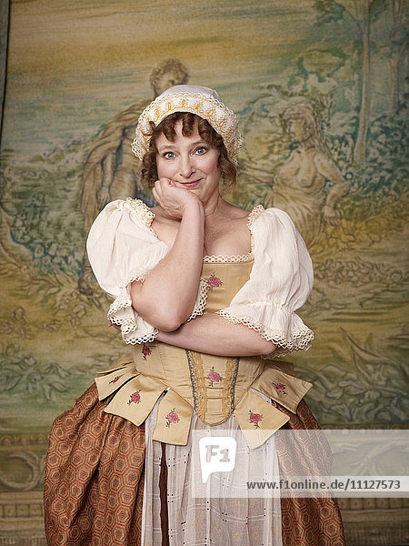 Actress dressed in old-fashioned costume on stage