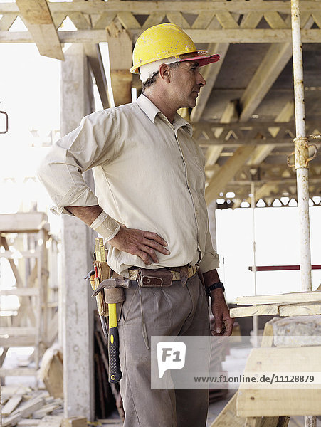 Hispanic worker standing at construction site