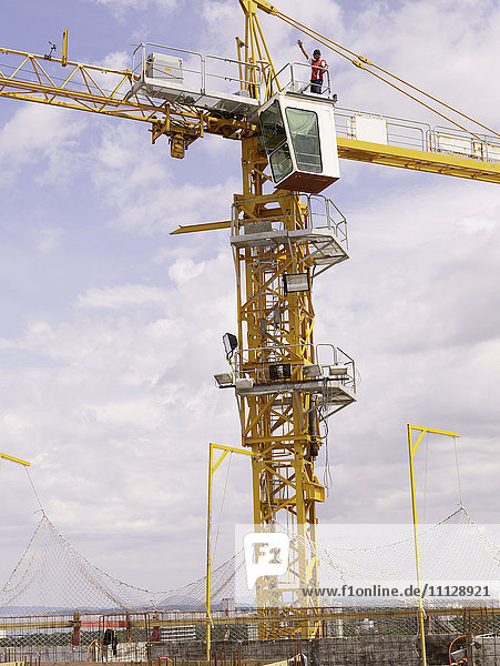 Construction worker on top of crane