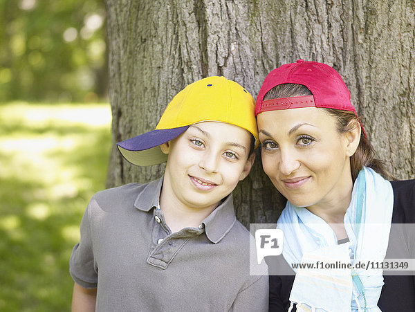 Mother and son wearing baseball caps