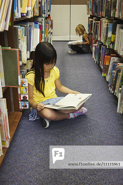 Mädchen lesen Bücher in der Bibliothek