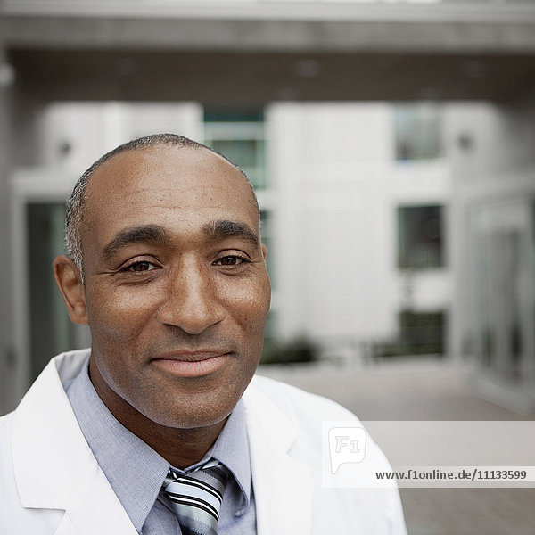 Mixed race doctor standing outdoors