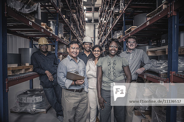 Workers standing together in factory