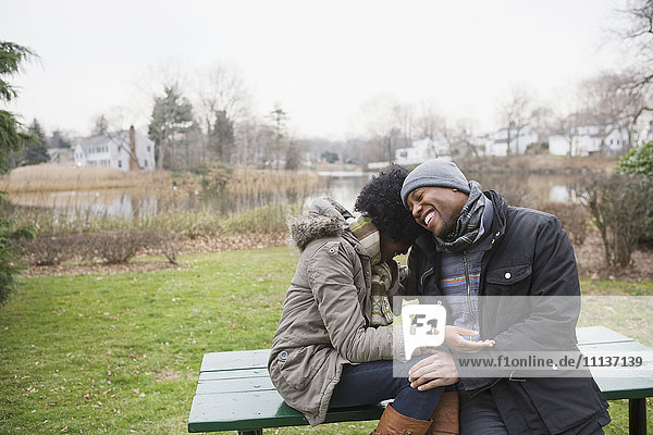 Couple laughing together in park