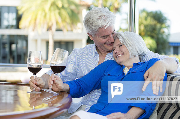 Älteres kaukasisches Paar trinkt zusammen Wein auf einem Boot