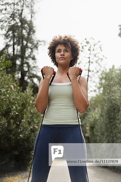 Mixed race woman exercising in park