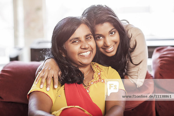 Lächelnde indische Mutter und Tochter