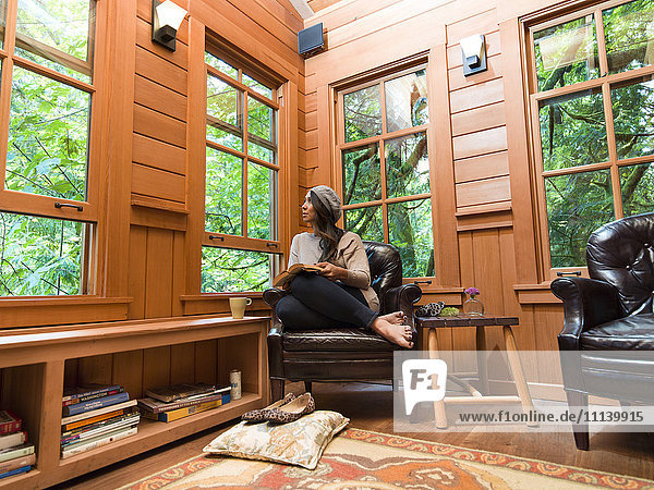 Filipino woman reading in chair