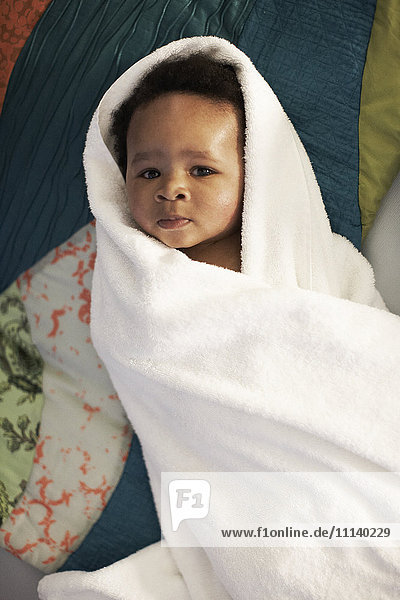 African American baby wrapped in towel