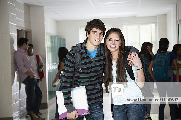 High school friends standing in corridor together