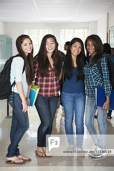 High school friends standing in corridor together