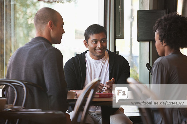 Friends sitting together in cafe