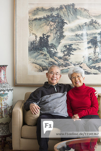 Chinese couple sitting on sofa