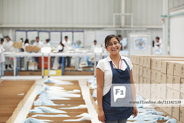 Worker smiling in manufacturing plant