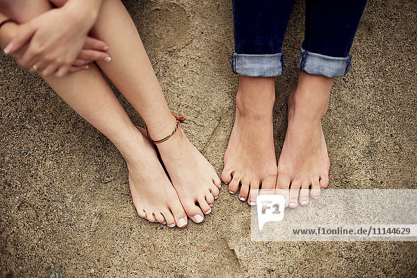 Close up of barefoot girls on rock