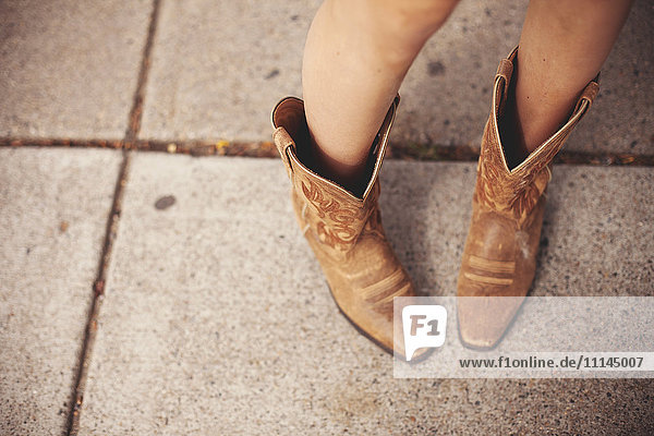 High angle view of woman wearing cowboy boots
