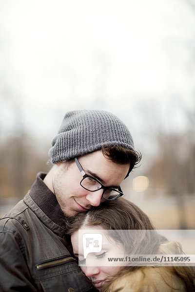 Couple hugging outdoors