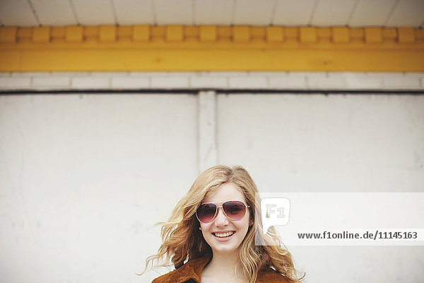 Kaukasisches Teenager-Mädchen lächelnd mit Sonnenbrille
