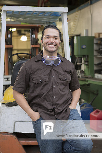 Hispanic worker smiling in warehouse
