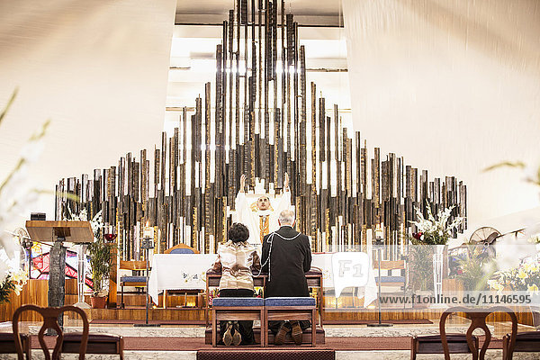 Couple praying at wedding in church