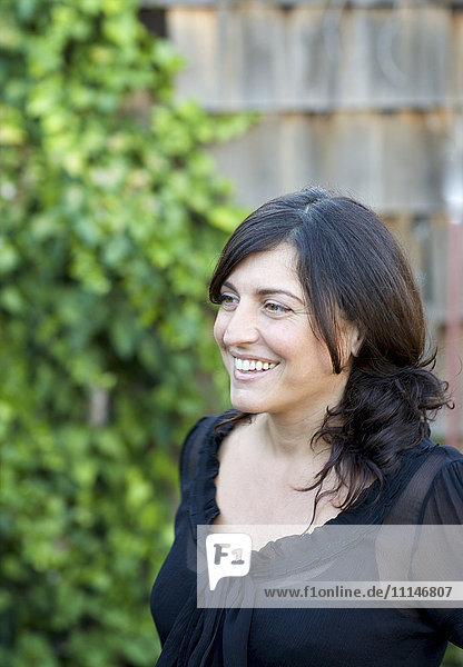 Close up of smiling woman in backyard