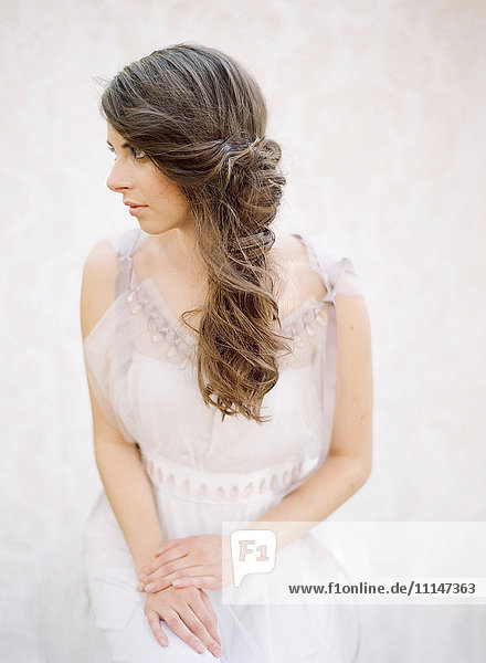 Bride with curled hair in wedding dress