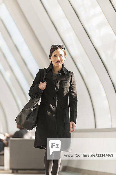 Japanese businesswoman walking in lobby