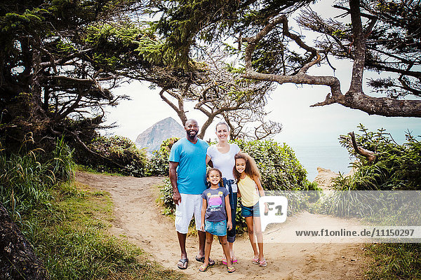 Family smiling on beach path