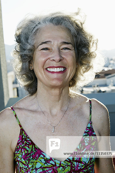 Caucasian woman smiling on urban rooftop
