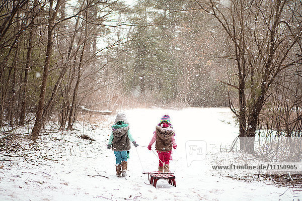 Girls walking in snowy field