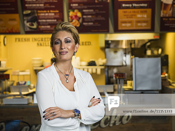 Hispanic woman smiling in cafe