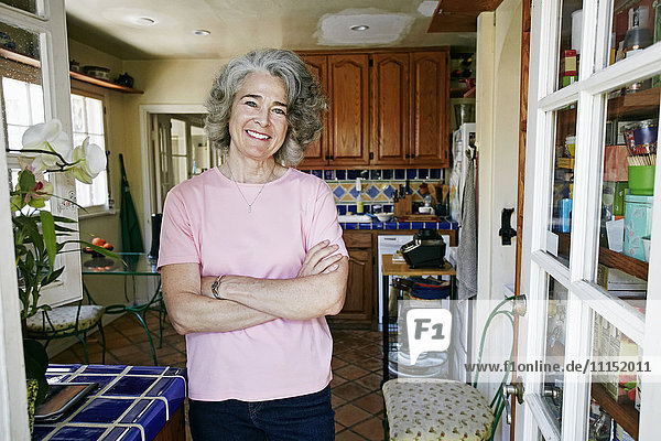 Caucasian woman smiling in kitchen