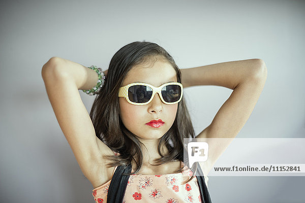 Gemischtrassiges Mädchen mit Make-up und Sonnenbrille