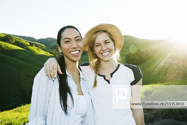 Women smiling on rural hilltop