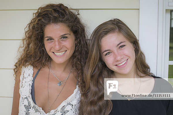 Caucasian teenage girls smiling outdoors