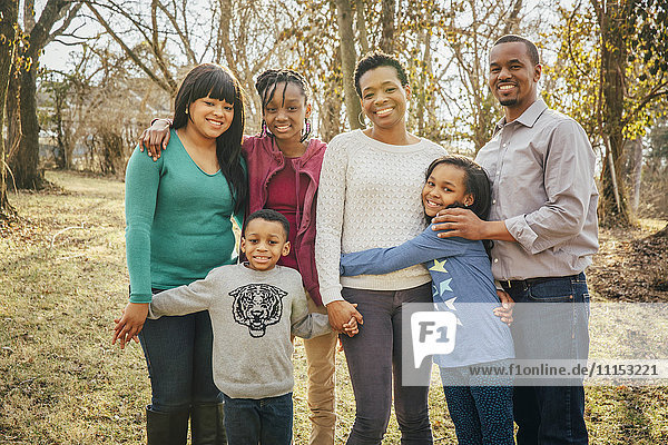 Black family smiling outdoors