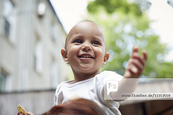 Mixed race baby boy smiling outdoors