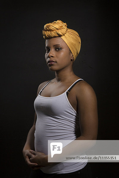 Ernste schwarze Frau mit Kopfbedeckung