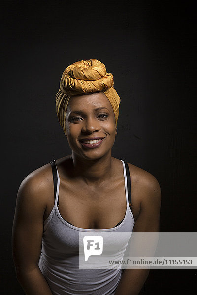 Lächelnde schwarze Frau mit Kopfbedeckung