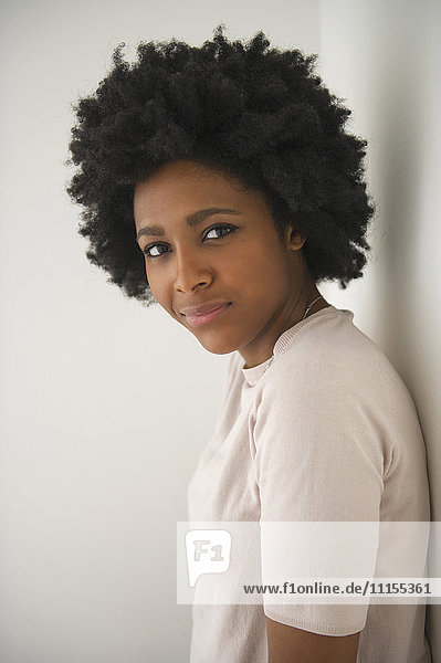Black woman leaning on wall
