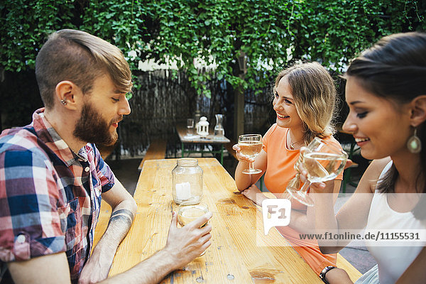 Friends drinking spritzer at outdoor pub