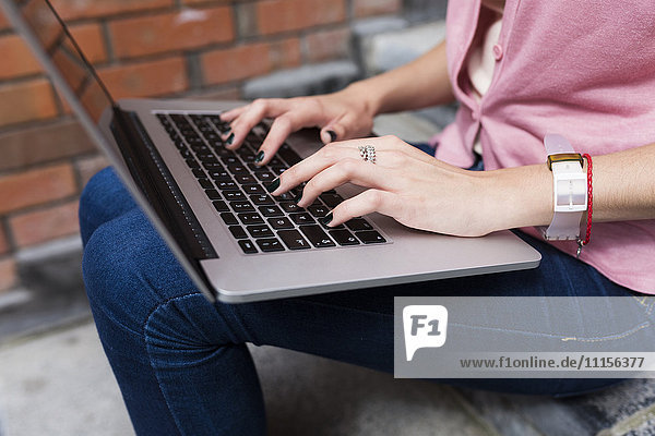 Woman's hands on keyboard of laptop
