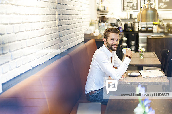 Businessman sitting in a cafe with cup of coffee