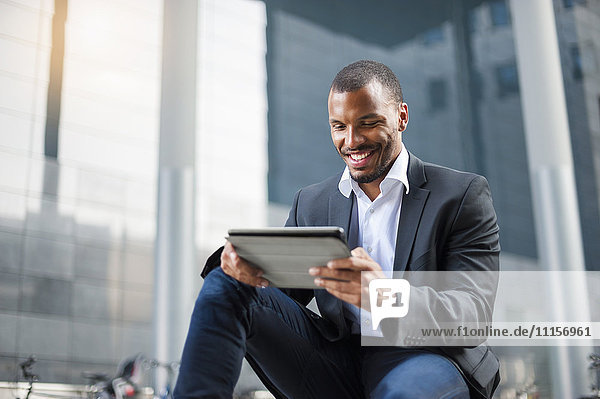 Smiling businessman using tablet