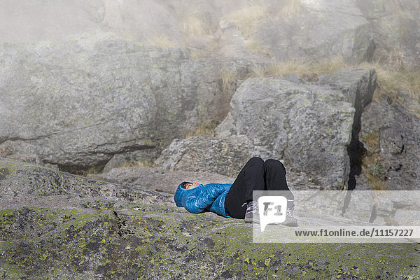 Spain  Sierra de Gredos  woman resting in the mountains