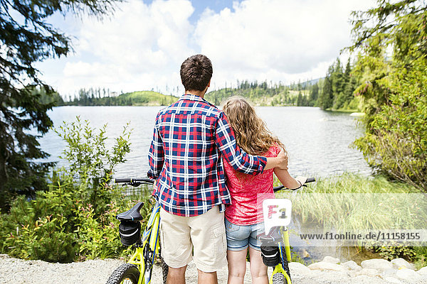 Young couple looking at view on a bicycle trip