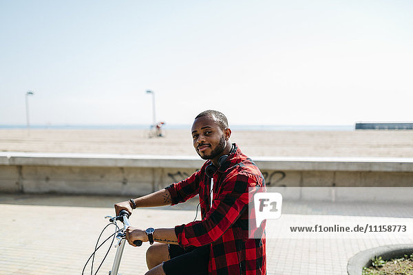 Man on bicycle near beach
